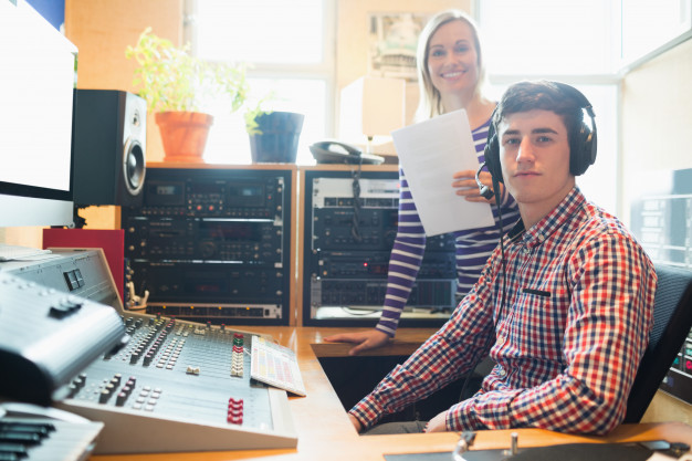 portrait-male-radio-host-with-female-employee_13339-290208
